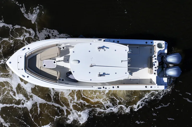 Slide: The Image of Aerial view of 2018 Sailfish 290 CC boat navigating through water. - 12