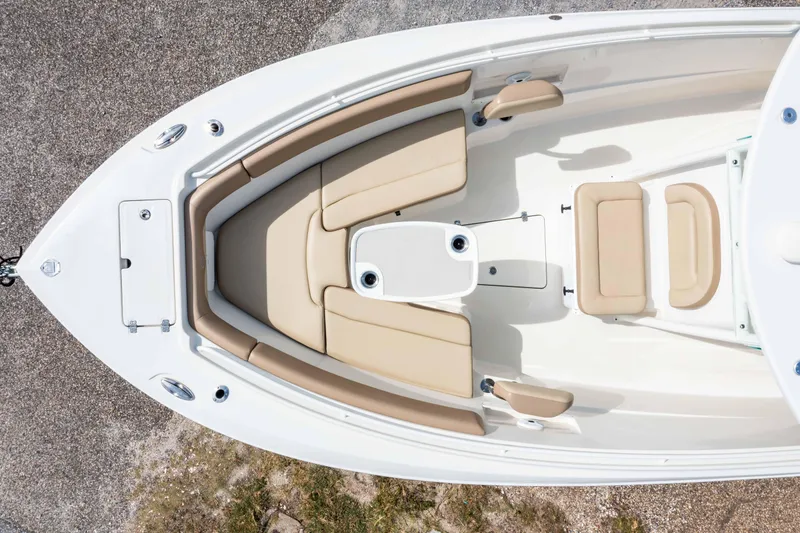 Slide: The Image of 2018 Sailfish 290 CC boat interior with beige seating and central table, aerial view. - 14