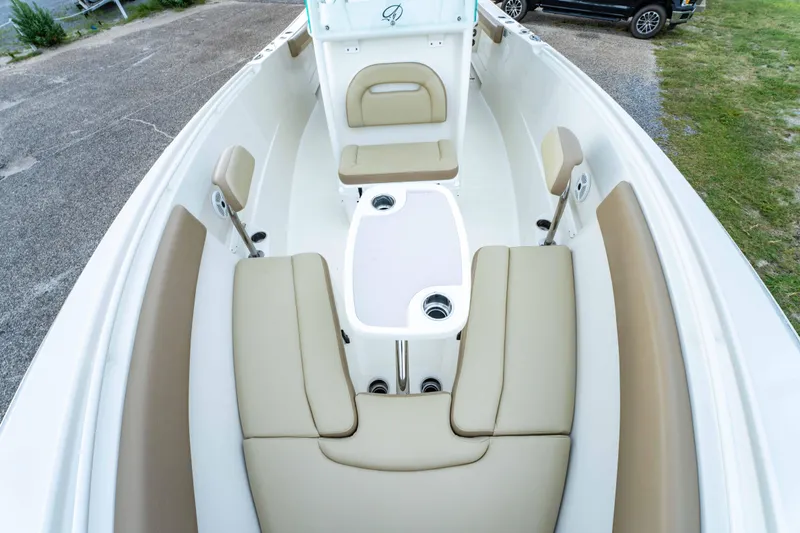Slide: The Image of 2018 Sailfish 290 CC boat interior with beige seating and white deck. - 17
