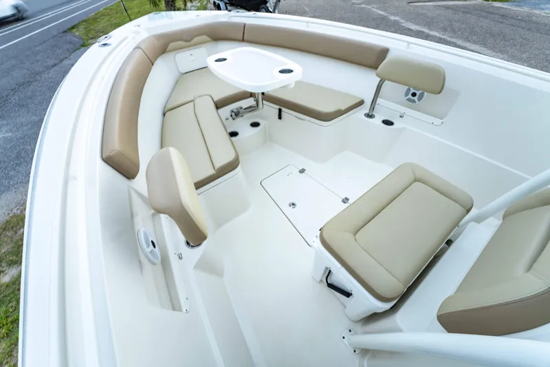 Slide: The Image of 2018 Sailfish 290 CC boat interior with beige seating and a round table. - 18