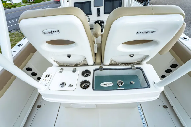 Slide: The Image of 2018 Sailfish 290 CC boat interior with dual seats and fishing equipment. - 23