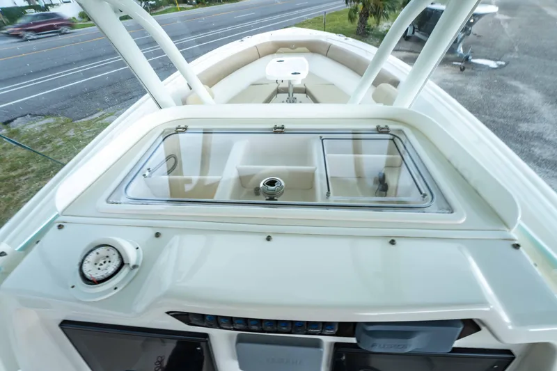 Slide: The Image of 2018 Sailfish 290 CC boat interior with seating and storage compartments. - 26