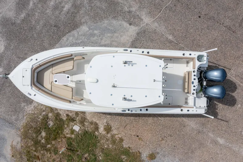 Slide: The Image of Aerial view of 2018 Sailfish 290 CC boat with dual engines on a gravel surface. - 31