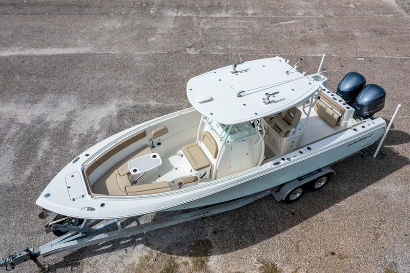 Slide: The Image of 2018 Sailfish 290 CC boat on trailer, aerial view, dual engines, spacious deck. - 32