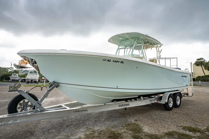 Slide: The Image of 2018 Sailfish 290 CC boat on trailer under cloudy sky. - 35