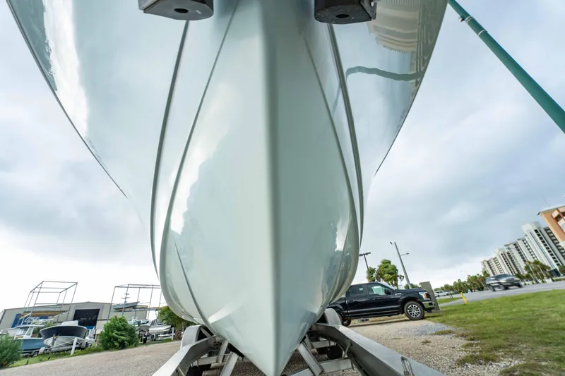 Slide: The Image of 2018 Sailfish 290 CC boat on trailer, viewed from below, with urban background. - 37