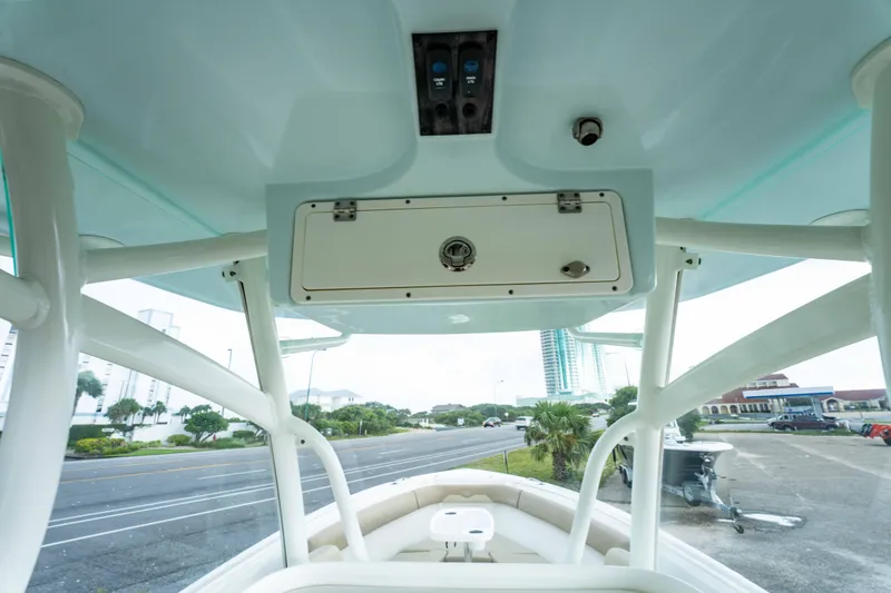 Slide: The Image of 2018 Sailfish 290 CC boat interior with overhead storage and view of the street. - 38