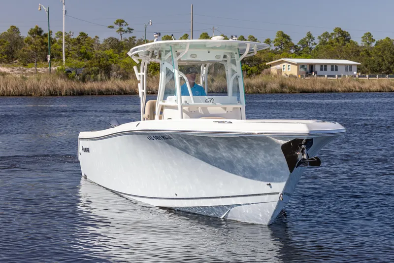 Slide: The Image of 2018 Sailfish 290 CC boat on calm water, front view. - 6