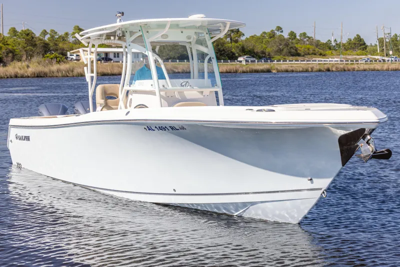 Slide: The Image of 2018 Sailfish 290 CC boat on calm water, showcasing sleek design and modern features. - 7