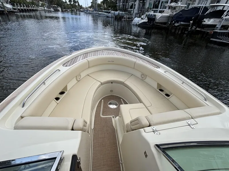 Slide: The Image of 2019 Chris-Craft Calypso 30 boat with elegant seating, docked in a serene marina. - 4