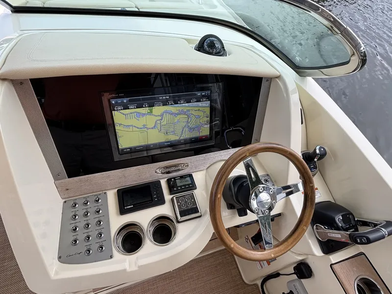 Slide: The Image of 2019 Chris-Craft Calypso 30 dashboard with navigation screen and steering wheel. - 6