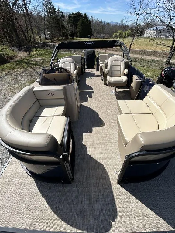 Slide: The Image of 2022 Manitou 21 Aurora LE RF VP II pontoon boat with spacious seating and modern design. - 2