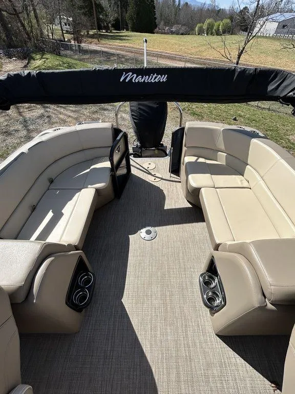 Slide: The Image of 2022 Manitou 21 Aurora LE RF VP II pontoon boat with beige seating and canopy. - 3