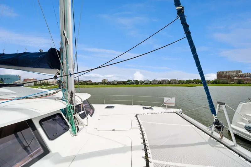 Slide: The Image of 2014 Fountaine Pajot Helia 44 catamaran on calm waters with cityscape background. - 17