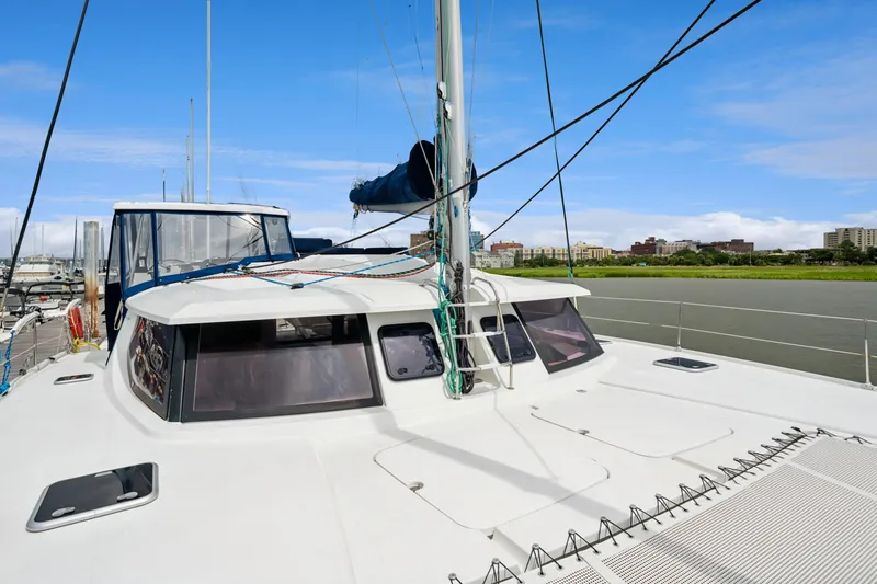 Slide: The Image of 2014 Fountaine Pajot Helia 44 catamaran docked, showcasing deck and cabin under clear blue sky. - 18