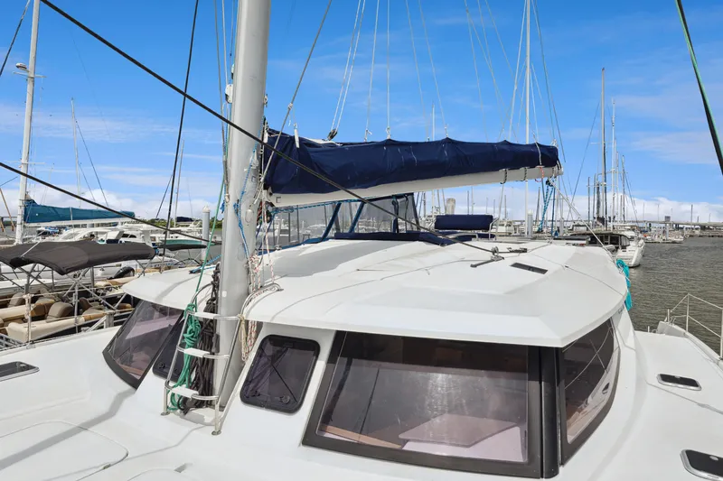 Slide: The Image of 2014 Fountaine Pajot Helia 44 catamaran docked at marina under clear blue sky. - 19
