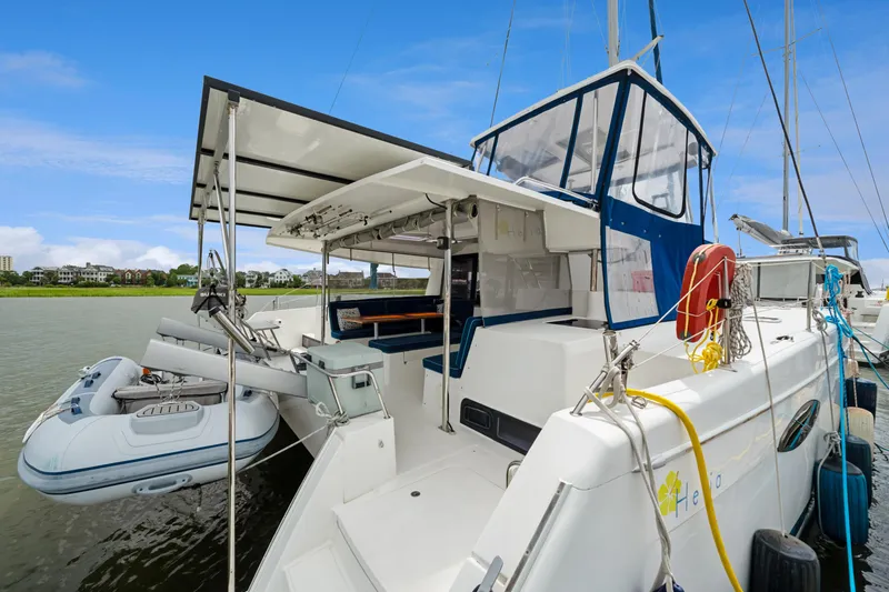 Slide: The Image of 2014 Fountaine Pajot Helia 44 catamaran docked with inflatable dinghy attached. - 21