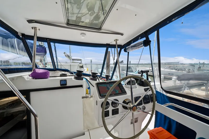 Slide: The Image of Helm of 2014 Fountaine Pajot Helia 44 catamaran with navigation equipment and clear canopy. - 24