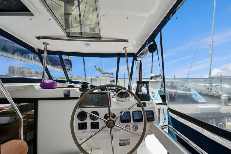 Slide: The Image of Helm of 2014 Fountaine Pajot Helia 44 catamaran with marina view. - 25