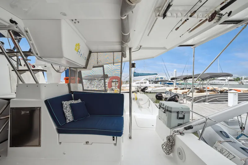 Slide: The Image of 2014 Fountaine Pajot Helia 44 catamaran interior with blue seating, docked at marina. - 30