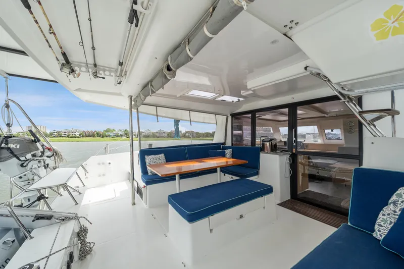 Slide: The Image of Spacious 2014 Fountaine Pajot Helia 44 catamaran cockpit with blue seating and dining area. - 31