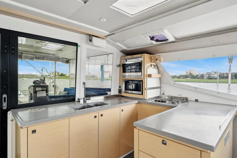 Slide: The Image of Modern kitchen interior of 2014 Fountaine Pajot Helia 44 catamaran with appliances and scenic window view. - 38
