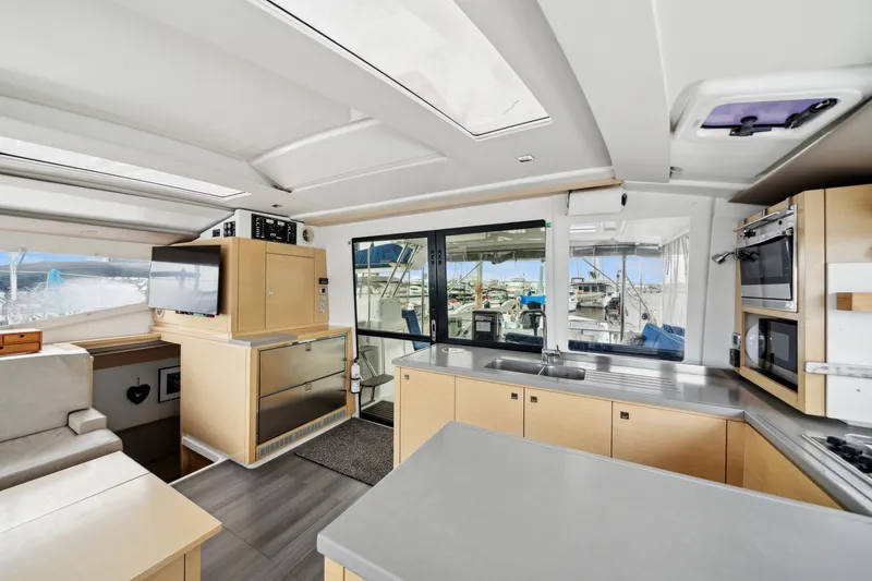 Slide: The Image of Spacious interior of 2014 Fountaine Pajot Helia 44 catamaran with modern kitchen and seating area. - 42