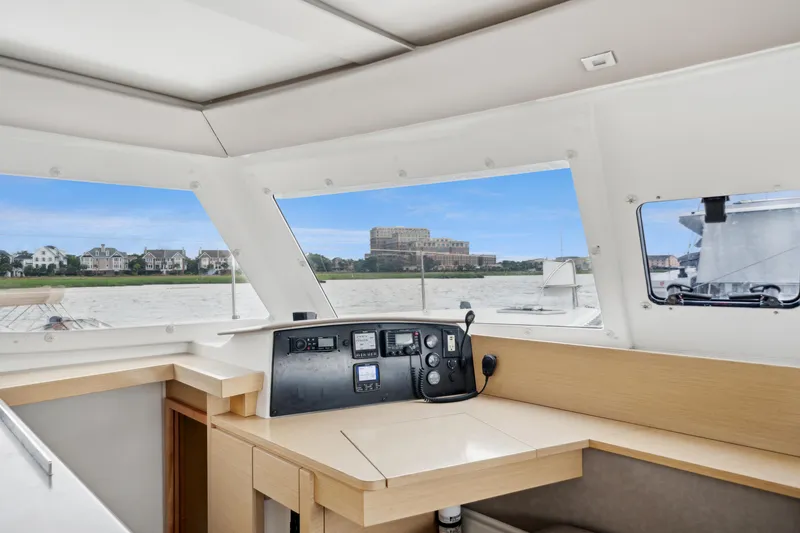 Slide: The Image of Helia 44 catamaran interior helm with scenic waterfront view, 2014 Fountaine Pajot model. - 44