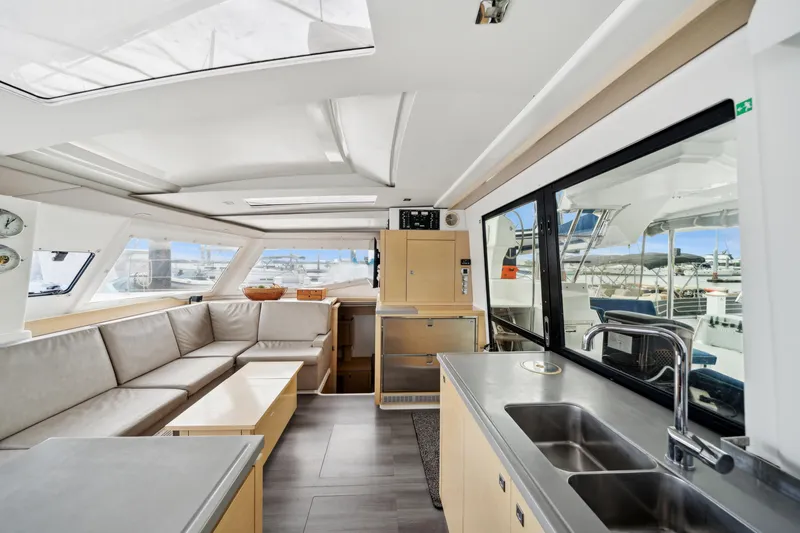 Slide: The Image of Interior of 2014 Fountaine Pajot Helia 44 catamaran with modern seating and kitchen area. - 46