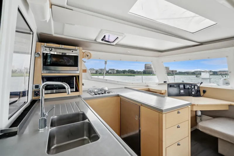 Slide: The Image of Interior of 2014 Fountaine Pajot Helia 44 catamaran with modern kitchen and navigation area. - 47