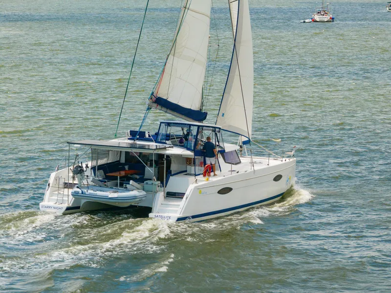 Slide: The Image of 2014 Fountaine Pajot Helia 44 catamaran sailing on open water. - 7