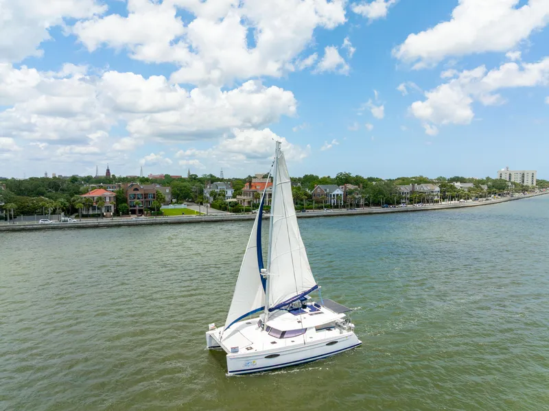 Slide: The Image of Sailing catamaran Fountaine Pajot Helia 44, 2014, cruising near a scenic waterfront. - 8