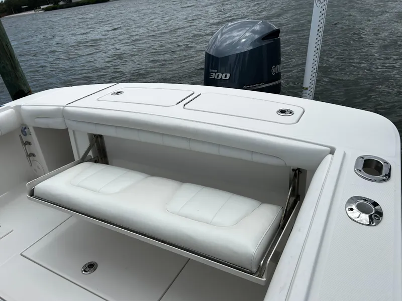 Slide: The Image of 2018 Regulator 23 Forward Seating boat with Yamaha 300 engine, featuring white cushioned seating. - 11