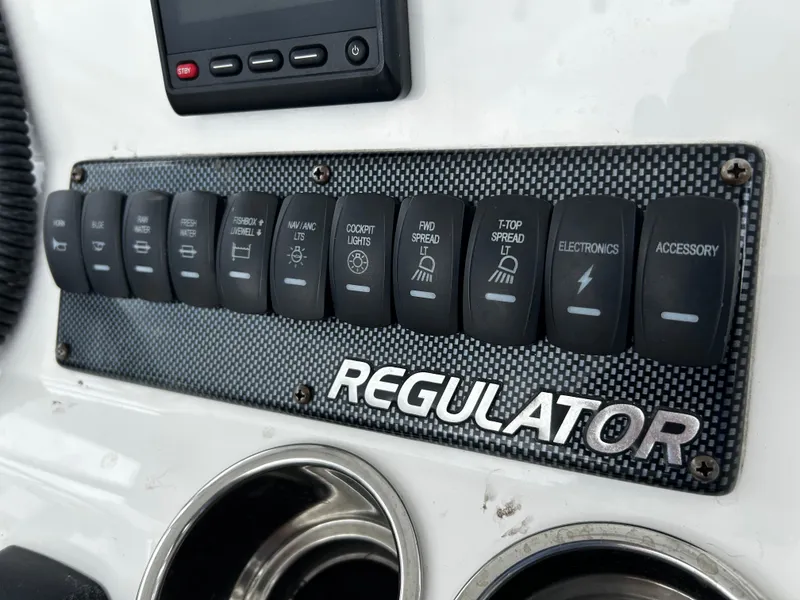 Slide: The Image of Control panel of 2018 Regulator 23 Forward Seating boat with labeled switches. - 24