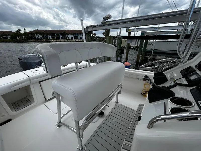 Slide: The Image of 2018 Regulator 23 Forward Seating boat interior with white seating and control panel. - 26