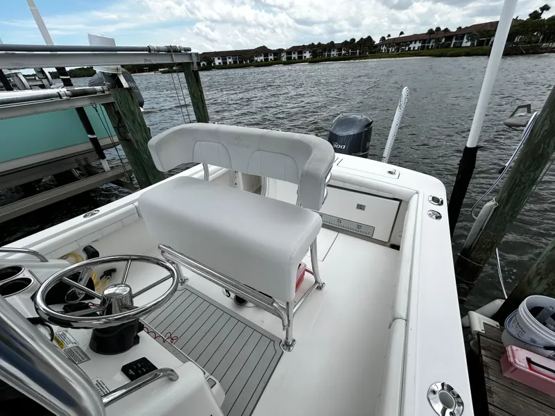 Slide: The Image of 2018 Regulator 23 Forward Seating boat docked by the water. - 28