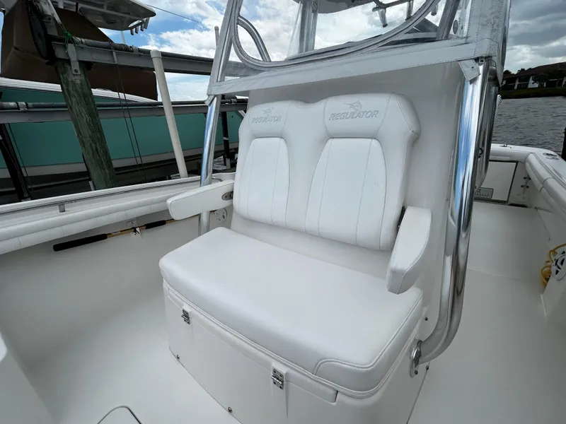 Slide: The Image of 2018 Regulator 23 Forward Seating boat with white cushioned seats and sleek design. - 31