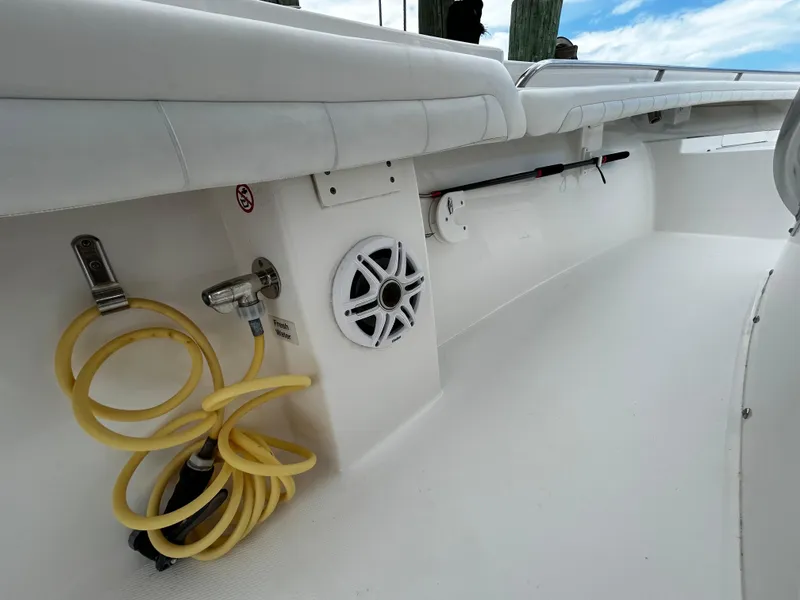 Slide: The Image of 2018 Regulator 23 Forward Seating boat interior with hose and speaker. - 35