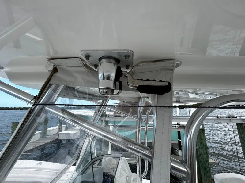 Slide: The Image of 2018 Regulator 23 Forward Seating boat with stainless steel T-top and clear enclosure. - 36