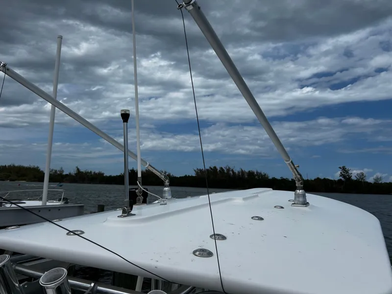 Slide: The Image of 2018 Regulator 23 Forward Seating boat with outriggers under cloudy sky. - 39