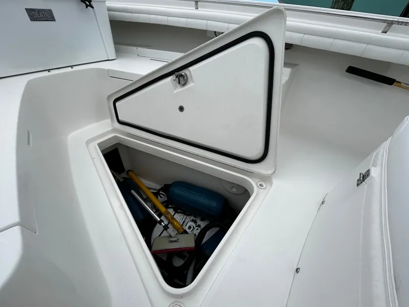 Slide: The Image of 2018 Regulator 23 Forward Seating boat storage compartment with various equipment inside. - 45