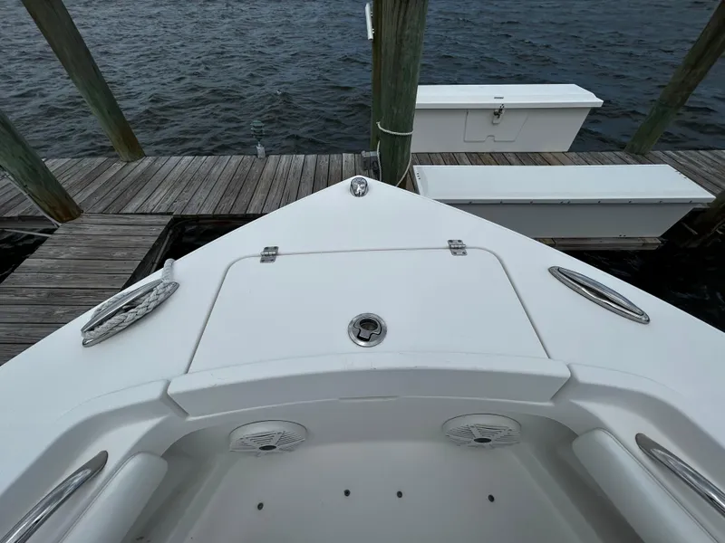 Slide: The Image of 2018 Regulator 23 Forward Seating boat docked by wooden pier. - 46