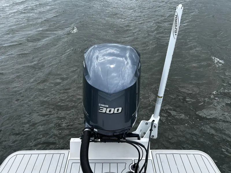 Slide: The Image of 2018 Regulator 23 Forward Seating boat with Yamaha 300 outboard motor on water. - 6