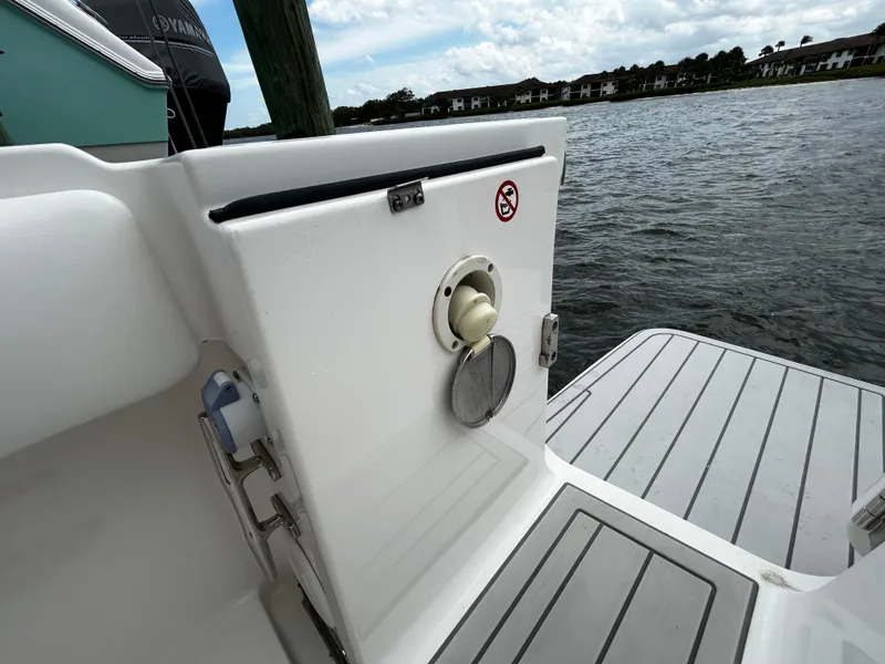 Slide: The Image of 2018 Regulator 23 Forward Seating boat, rear deck view by the water. - 8
