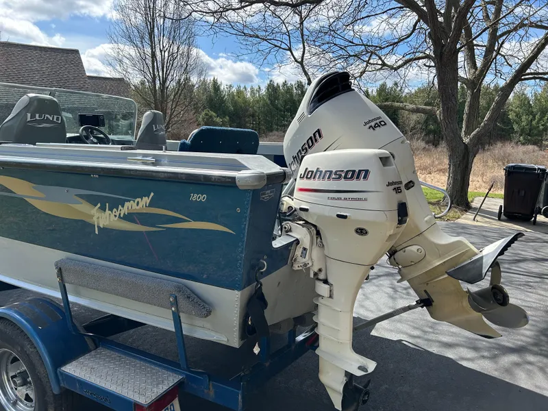Slide: The Image of 2003 Lund 1800 Fisherman boat with Johnson outboard motor on trailer. - 2