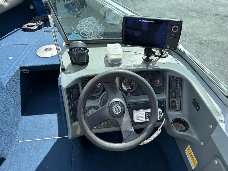 Slide: The Image of 2003 Lund 1800 Fisherman boat dashboard with steering wheel, gauges, and Humminbird fish finder. - 5