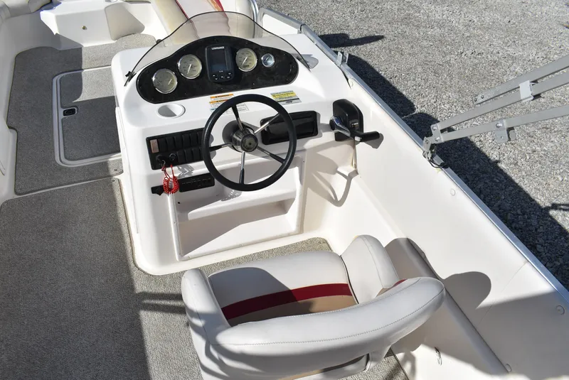 Slide: The Image of 2006 Hurricane FunDeck 228 RE boat cockpit with steering wheel and control panel. - 10