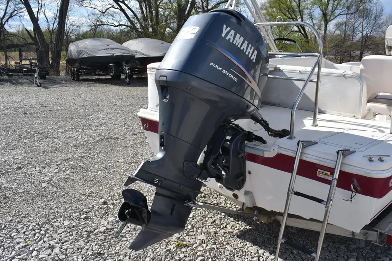 Slide: The Image of 2006 Hurricane FunDeck 228 RE with Yamaha outboard motor on gravel lot. - 6