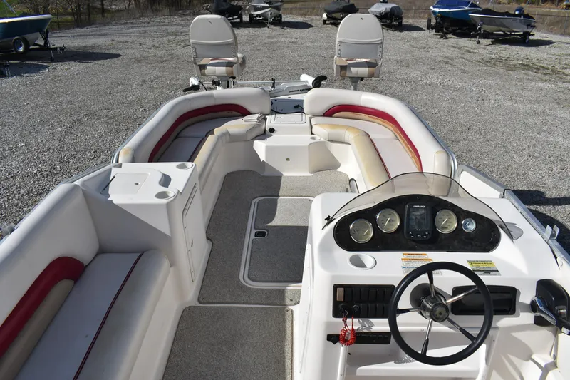 Slide: The Image of 2006 Hurricane FunDeck 228 RE boat interior with seating and steering console. - 9