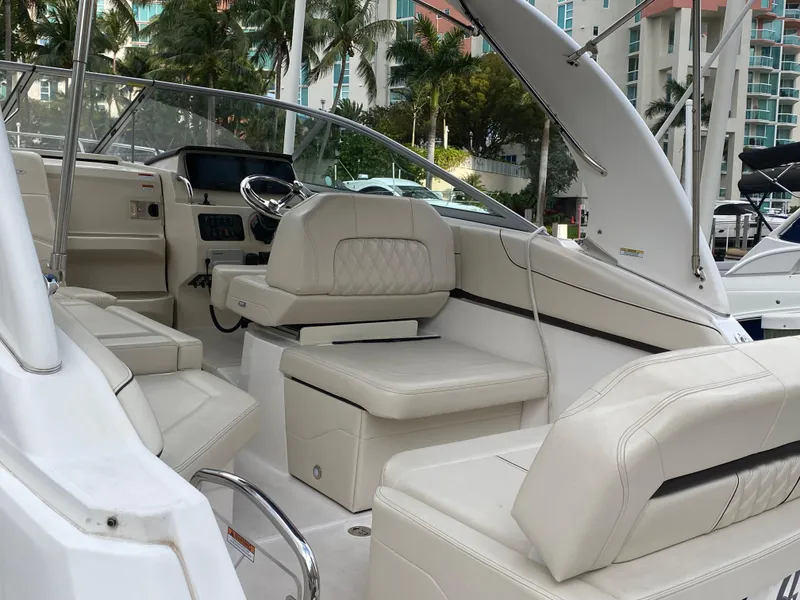 Slide: The Image of 2022 Regal 26 XO boat interior with luxurious white seating and modern dashboard. - 10